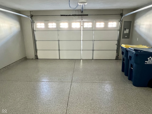 garage featuring electric panel and a garage door opener