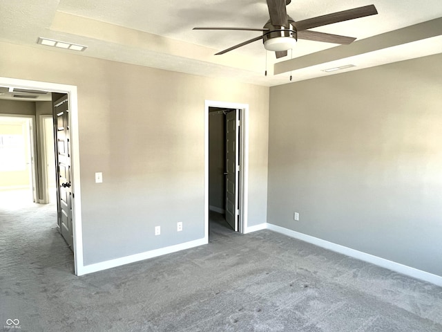 unfurnished bedroom with baseboards, carpet floors, and visible vents