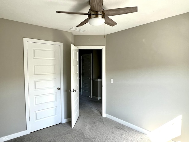 unfurnished bedroom with visible vents, baseboards, and carpet