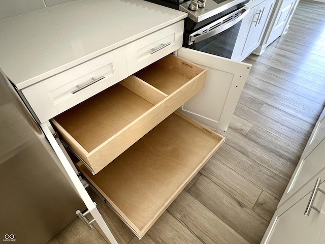 interior space with white cabinets and light wood-style floors