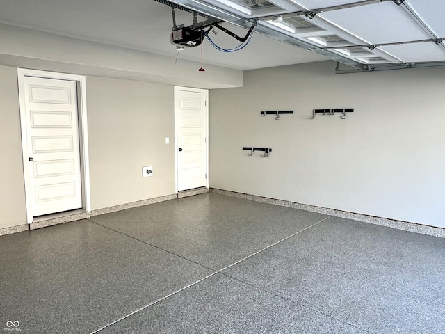 garage with baseboards and a garage door opener