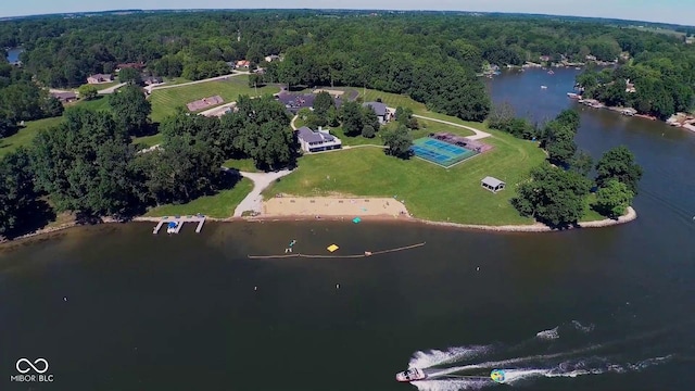 drone / aerial view featuring a water view and a view of trees