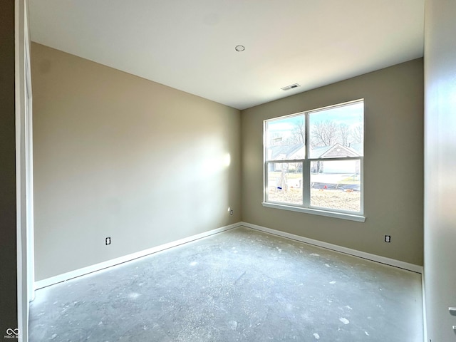 empty room featuring baseboards, visible vents, and concrete floors