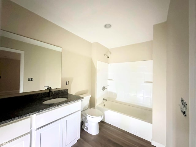 full bathroom with vanity, toilet, wood finished floors, and shower / washtub combination