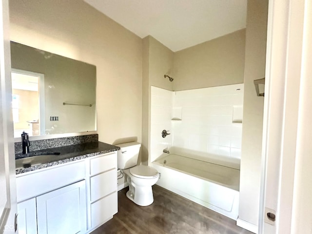 full bathroom with vanity, toilet, wood finished floors, and shower / bath combination