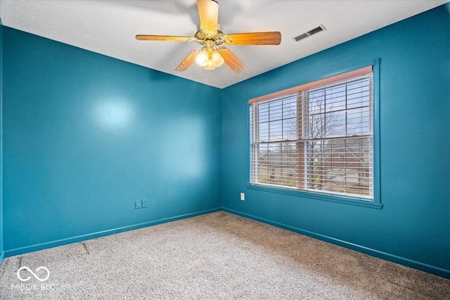 unfurnished room featuring visible vents, ceiling fan, baseboards, and carpet