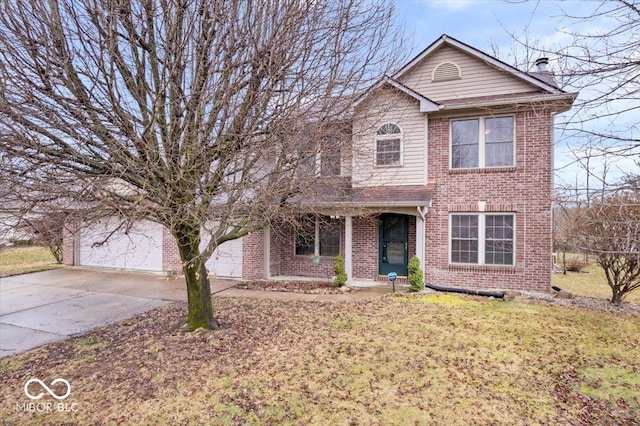 traditional-style house with a garage, driveway, a front lawn, and brick siding