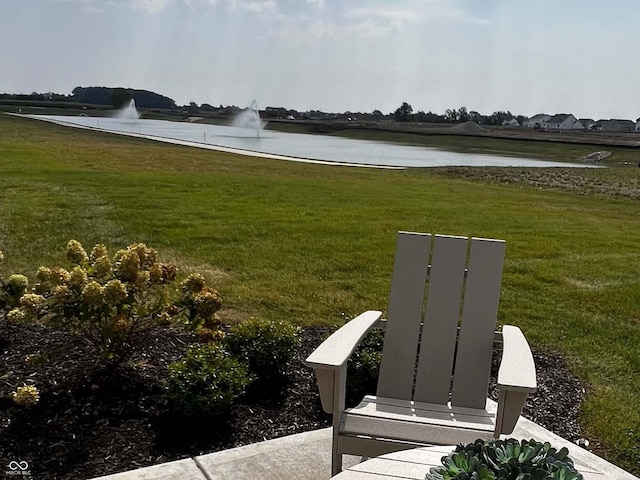 view of community with a water view and a lawn