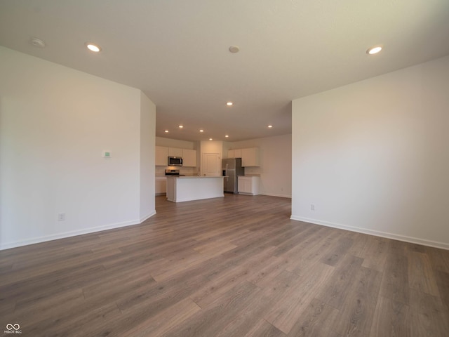 1366 Foxtail Ln, Greenwood, IN 46143 - unfurnished living room with dark wood-style flooring and recessed lighting