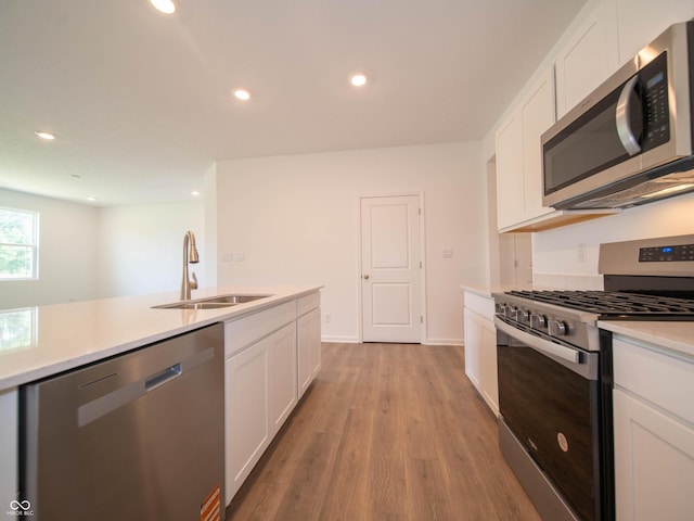1366 Foxtail Ln, Greenwood, IN 46143 - kitchen featuring stainless steel appliances, white cabinetry, light countertops, light wood-style floors, and recessed lighting