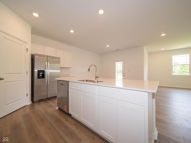 1366 Foxtail Ln, Greenwood, IN 46143 - kitchen featuring stainless steel appliances, dark wood-style floors, an island with sink, white cabinetry, and light countertops