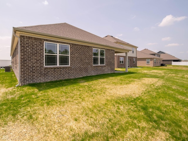 1366 Foxtail Ln, Greenwood, IN 46143 - rear view of house featuring brick siding, a yard, and roof with shingles