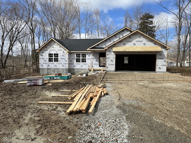 property under construction featuring driveway and an attached garage