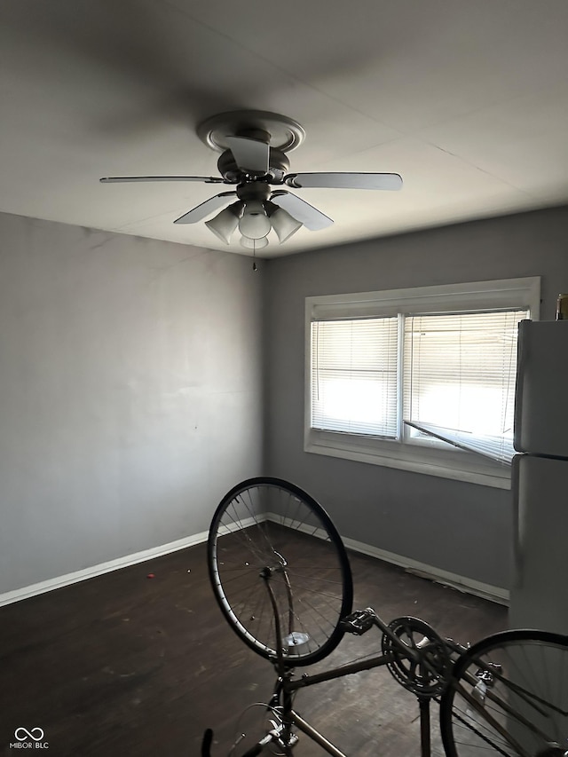 miscellaneous room featuring a ceiling fan and baseboards