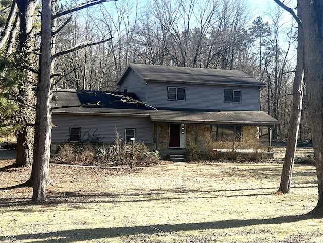 view of front facade featuring covered porch and stone siding