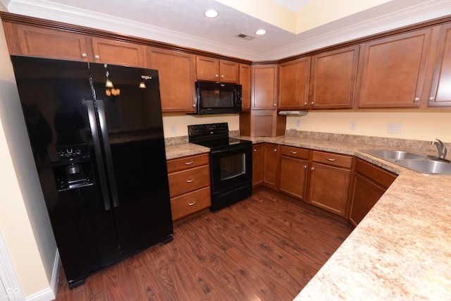 kitchen with visible vents, brown cabinetry, dark wood-style floors, black appliances, and a sink