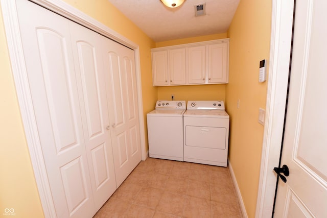 laundry room featuring cabinet space, visible vents, light tile patterned flooring, independent washer and dryer, and baseboards