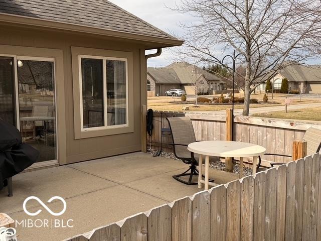 view of patio / terrace featuring a grill and fence