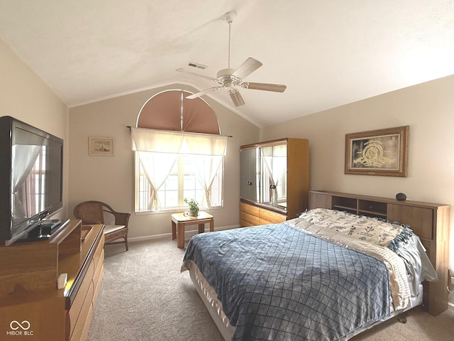 carpeted bedroom with visible vents, vaulted ceiling, baseboards, and ceiling fan