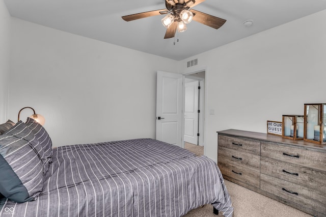 carpeted bedroom featuring visible vents and ceiling fan