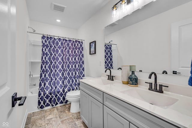 full bath featuring double vanity, toilet, visible vents, and a sink