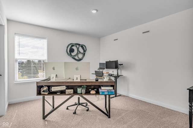 carpeted office featuring visible vents and baseboards