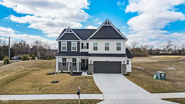 view of front of home with a garage, board and batten siding, concrete driveway, and a front lawn