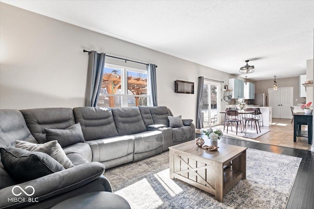 living room featuring light wood-style flooring and a textured ceiling