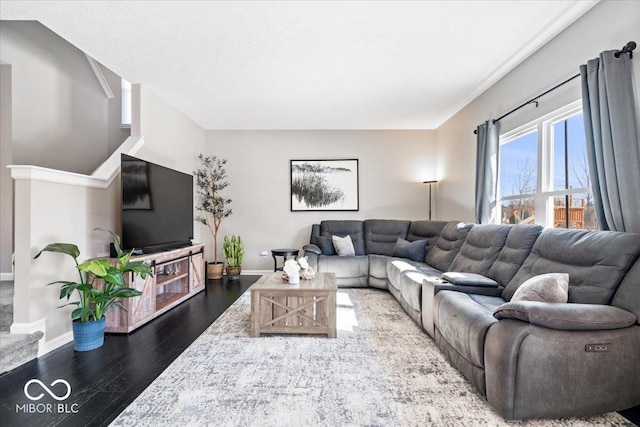 living room featuring baseboards and wood finished floors