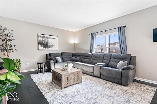 living area with baseboards and hardwood / wood-style floors