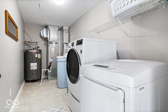 clothes washing area with water heater, a textured ceiling, laundry area, independent washer and dryer, and baseboards