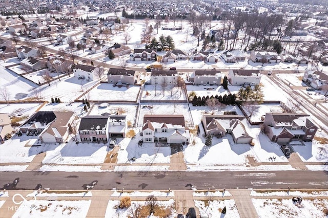 snowy aerial view with a residential view