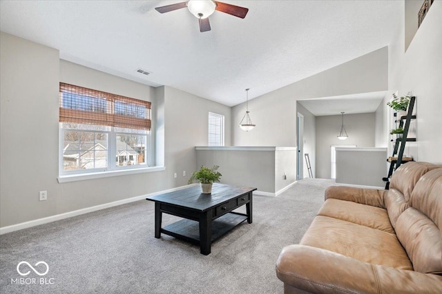 living area featuring carpet floors, lofted ceiling, visible vents, a ceiling fan, and baseboards