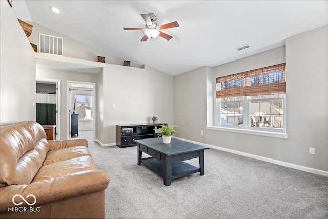 living room featuring carpet, visible vents, vaulted ceiling, and baseboards