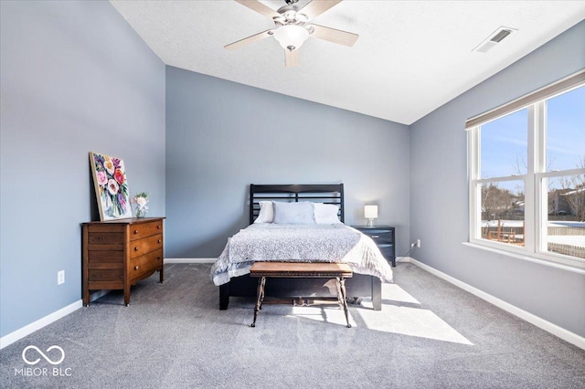 carpeted bedroom with a ceiling fan, lofted ceiling, visible vents, and baseboards