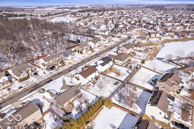 snowy aerial view with a residential view