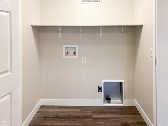 laundry room with dark wood-style floors, washer hookup, electric dryer hookup, laundry area, and baseboards