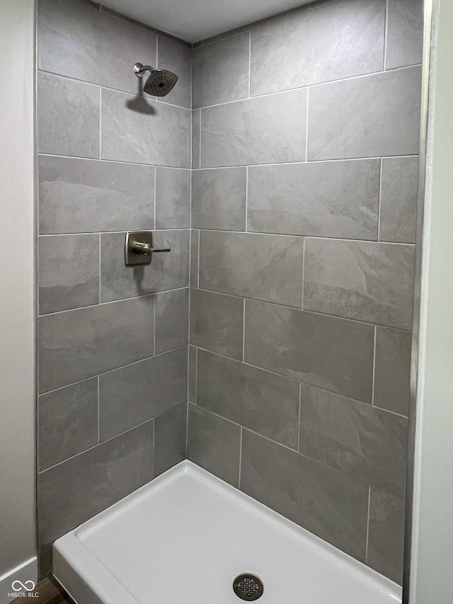 bathroom with a tile shower