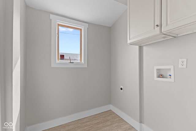 laundry area with washer hookup, wood finished floors, baseboards, cabinet space, and electric dryer hookup