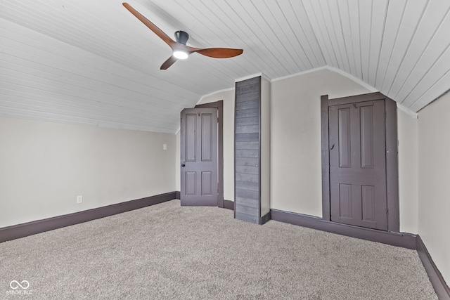 additional living space featuring carpet floors, lofted ceiling, a ceiling fan, wooden ceiling, and baseboards