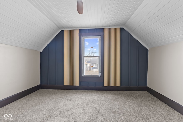 bonus room featuring lofted ceiling, carpet floors, ceiling fan, and baseboards