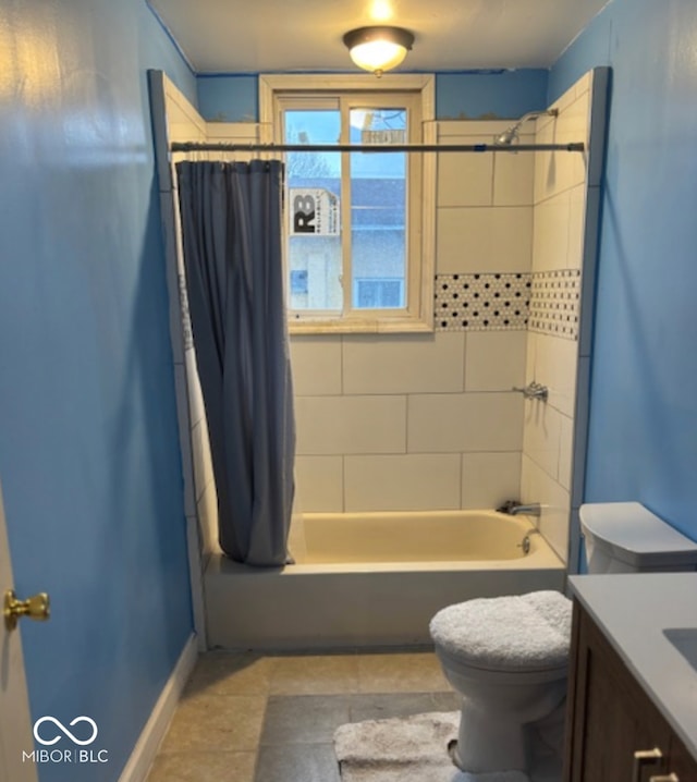 bathroom with baseboards, vanity, toilet, and shower / bath combo with shower curtain