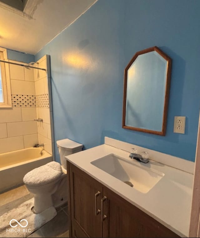 full bath featuring toilet, tile patterned flooring,  shower combination, and vanity