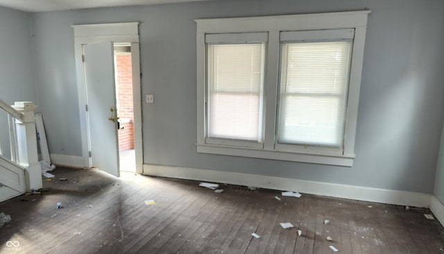 interior space with wood-type flooring and baseboards