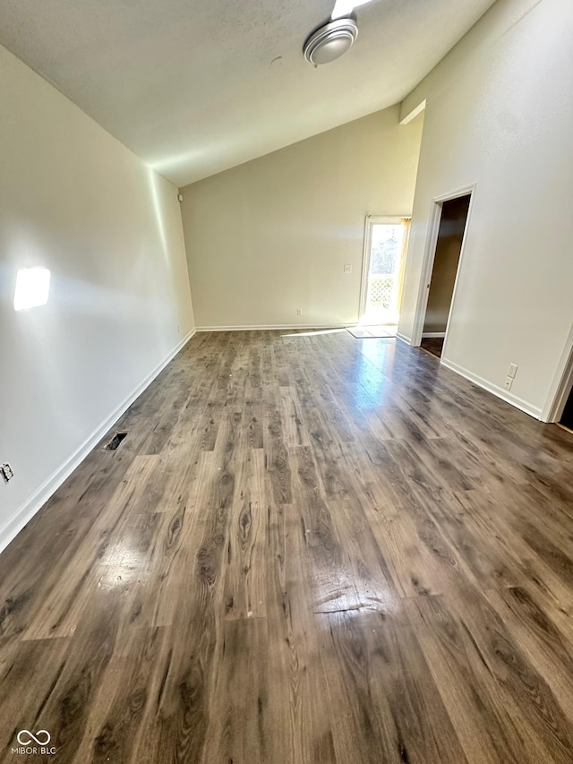 unfurnished living room featuring high vaulted ceiling, baseboards, and dark wood finished floors