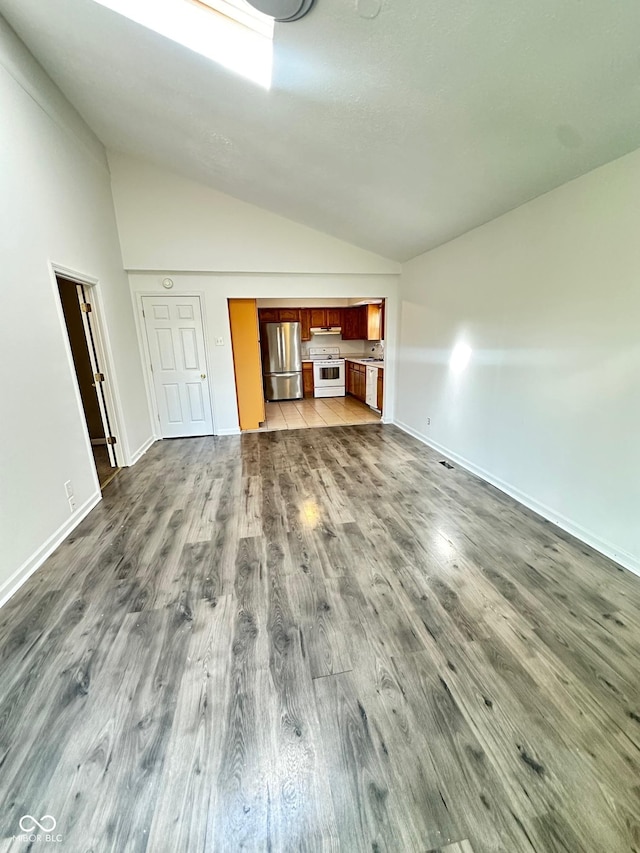 unfurnished living room with high vaulted ceiling, baseboards, and dark wood-style flooring