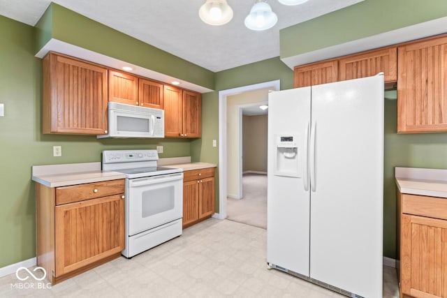 kitchen featuring light floors, white appliances, light countertops, and baseboards