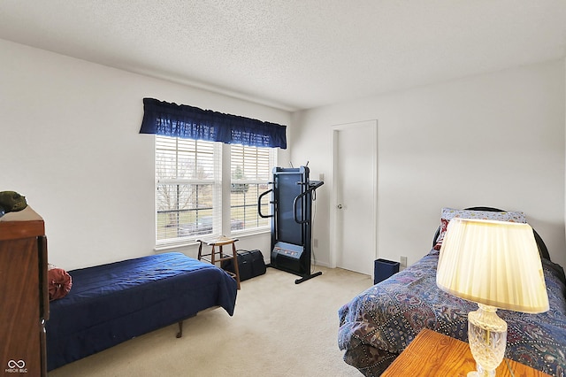 carpeted bedroom featuring a textured ceiling