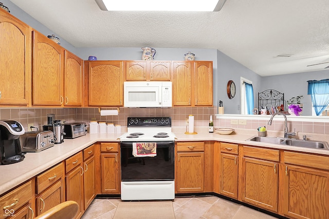 kitchen with visible vents, a sink, range with electric stovetop, light countertops, and white microwave