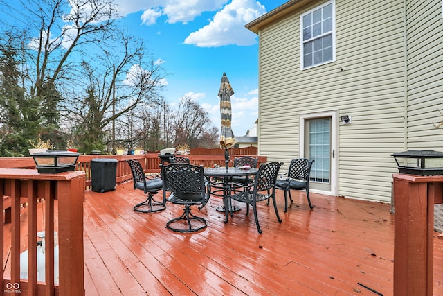 wooden terrace featuring outdoor dining area